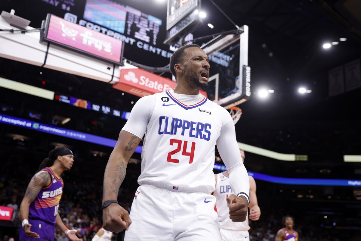 Clippers guard Norman Powell clenches his fists and flexes along the baseline after scoring a basket.