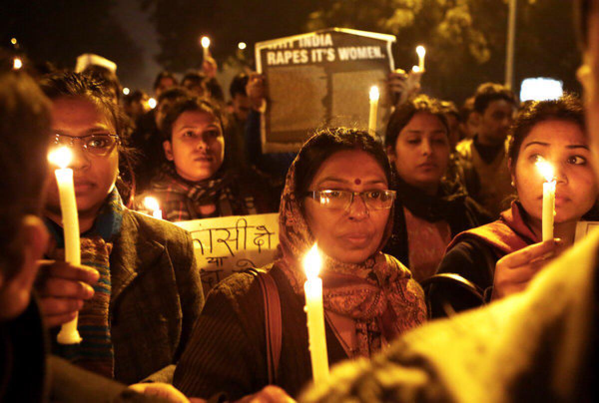 Indian protesters hold candles and block a road during a December rally in New Delhi after the cremation of a woman who was gang-raped and died of her injuries two weeks later.
