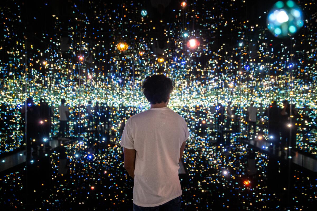Daniel Evans, 28, of Los Angeles quietly looks around Yayoi Kusama's "Infinity Mirrored Room — The Souls of Millions of Light Years Away," on display at the Broad.