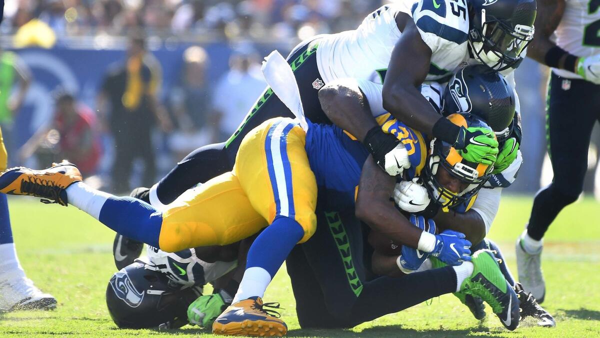 Rams running back Todd Gurley is brought down by Seattle Seahawks defenders in the fourth quarter at the Coliseum on Sept. 18.