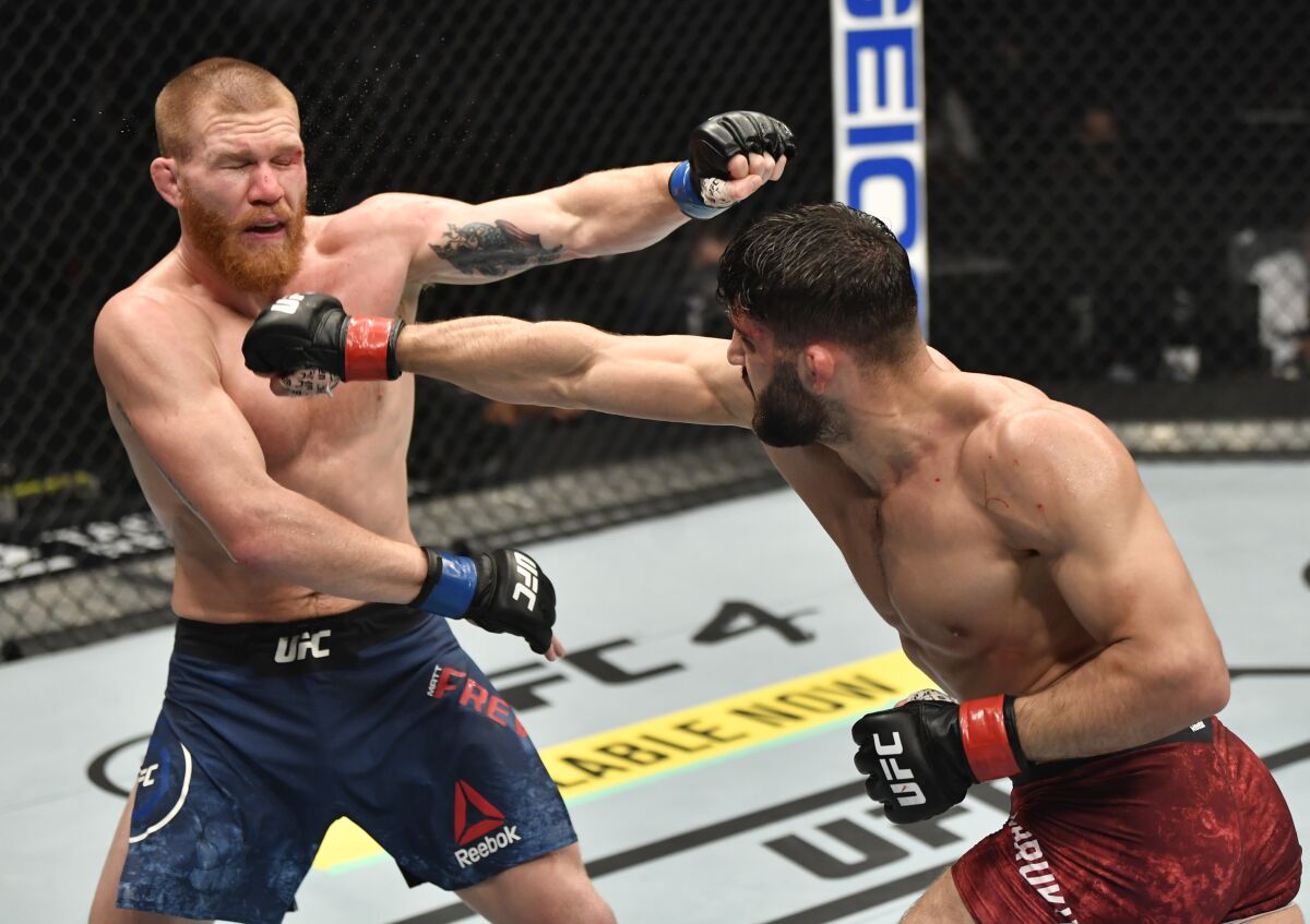 Arman Tsarukyan, right, punches Matt Frevola during their lightweight fight at UFC 257 on Saturday.