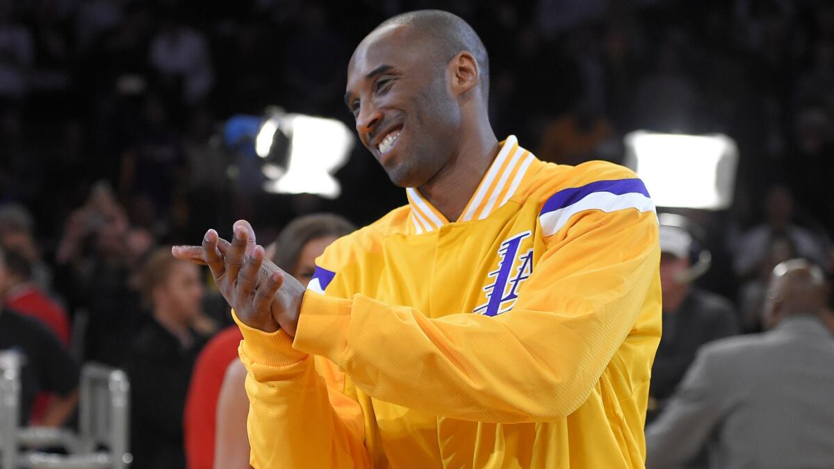 Lakers star Kobe Bryant claps during a ceremony recognizing him as the third-leading scorer in NBA history at Staples Center on Dec. 19.