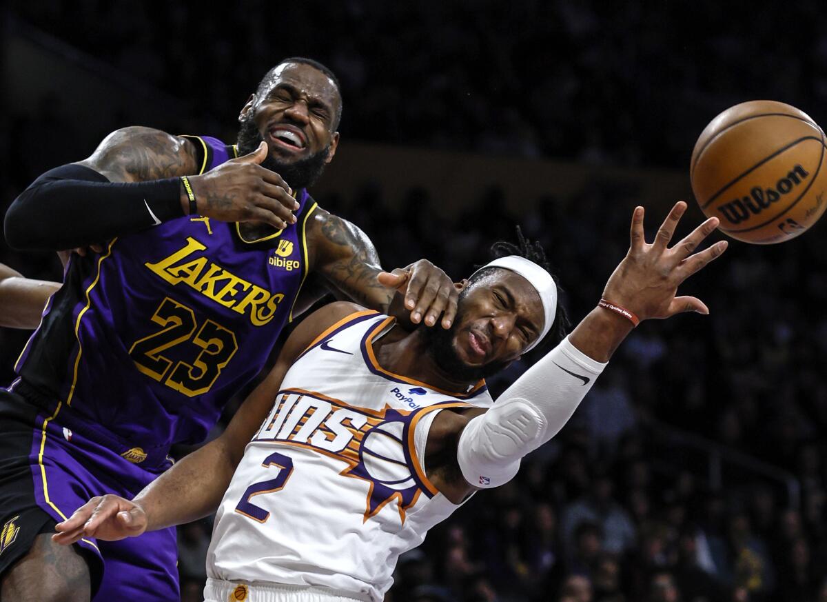 Lakers star LeBron James, left, is fouled by Phoenix Suns forward Josh Okogie at Crypto.com Arena.