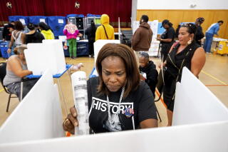 Sheron Campbell wears a Kamala Harris shirt while voting Tuesday in Oakland, Calif.