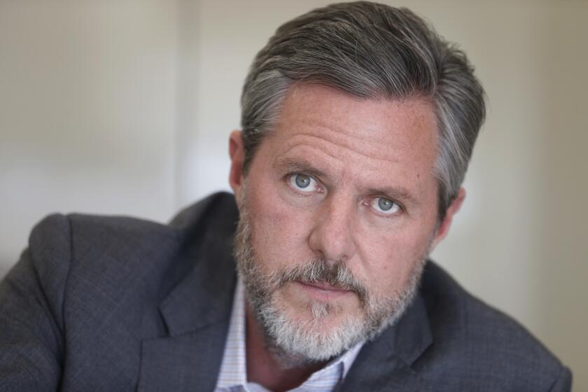 FILE - In this Nov. 16, 2016 file photo, Liberty University president Jerry Falwell Jr., poses during an interview in his offices at the school in Lynchburg, Va. Falwell Jr. apologized Monday, June 8, 2020 for a tweet that included a racist photo that appeared on Gov. Ralph Northam's medical school yearbook page decades ago, saying his effort to make a political point had been offensive. (AP Photo/Steve Helber, File)