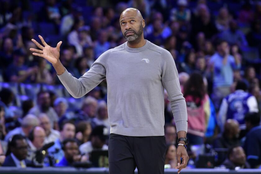 Orlando Magic head coach Jamahl Mosley stands on the court during a timeout in the first half of an NBA basketball game against the Memphis Grizzlies Tuesday, March 28, 2023, in Memphis, Tenn. (AP Photo/Brandon Dill)