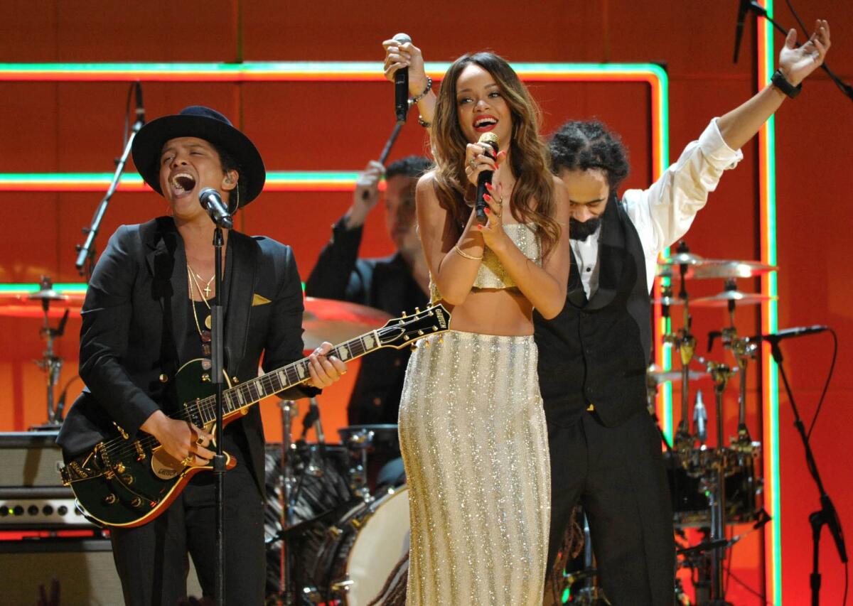 Bruno Mars, left, Rihanna and Damien Marley perform during the Bob Marley tribute at the 2013 Grammy Awards.