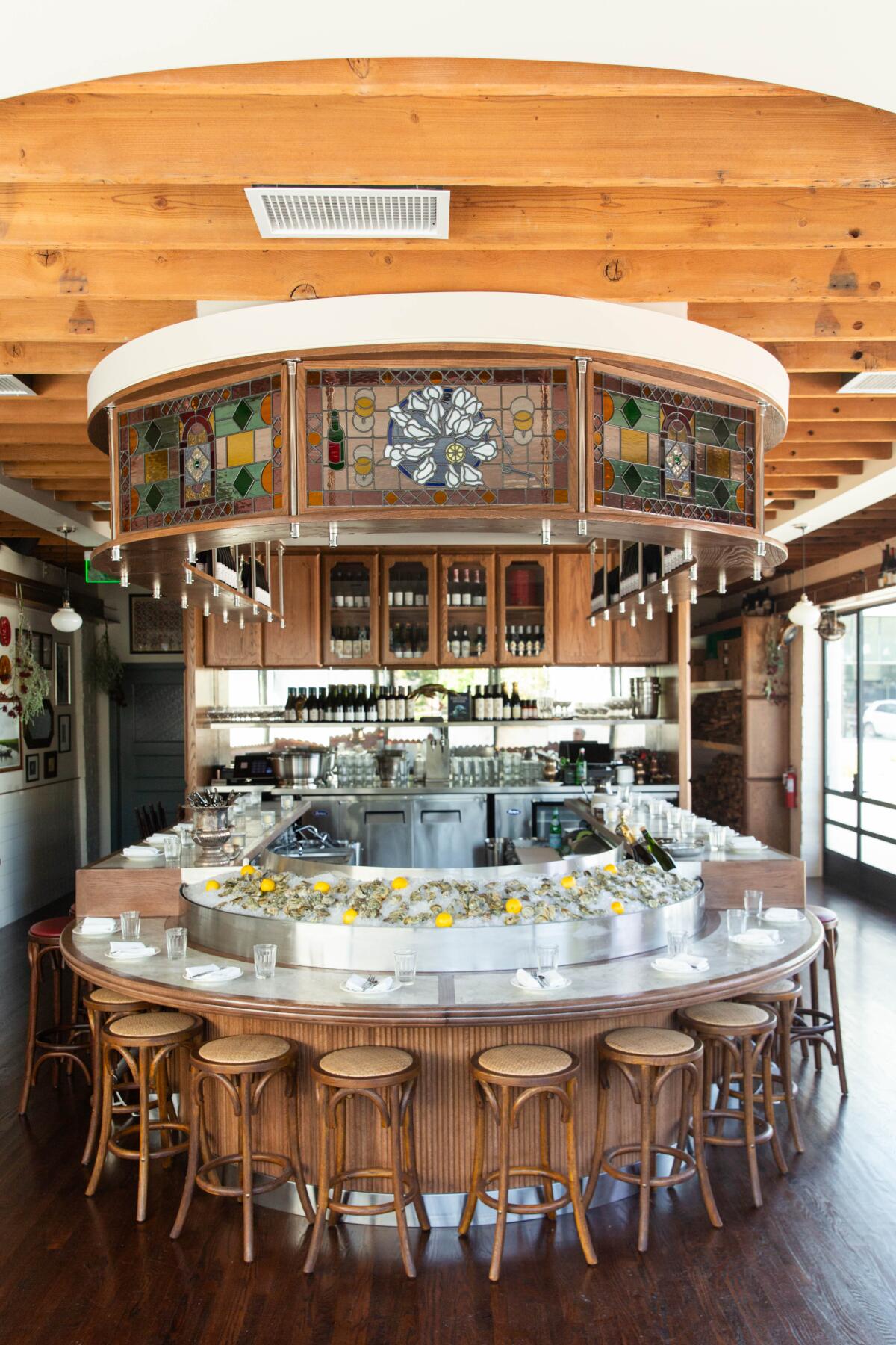 A semi-circular bar with barstools at Queen Street restaurant in Eagle Rock