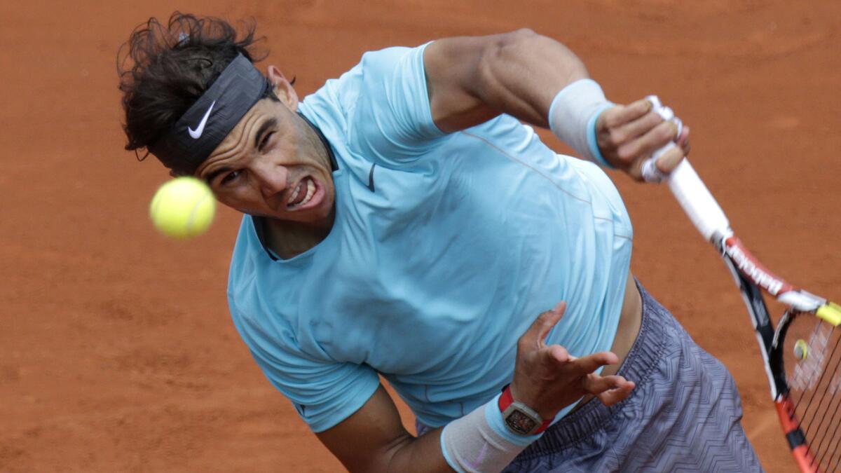 Rafael Nadal returns a shot during his victory over Dusan Lajovic at the French Open on Monday.