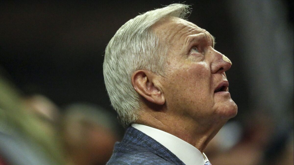 Jerry West checks the scoreboard from a courtside seat as the Clippers played the Suns last season.