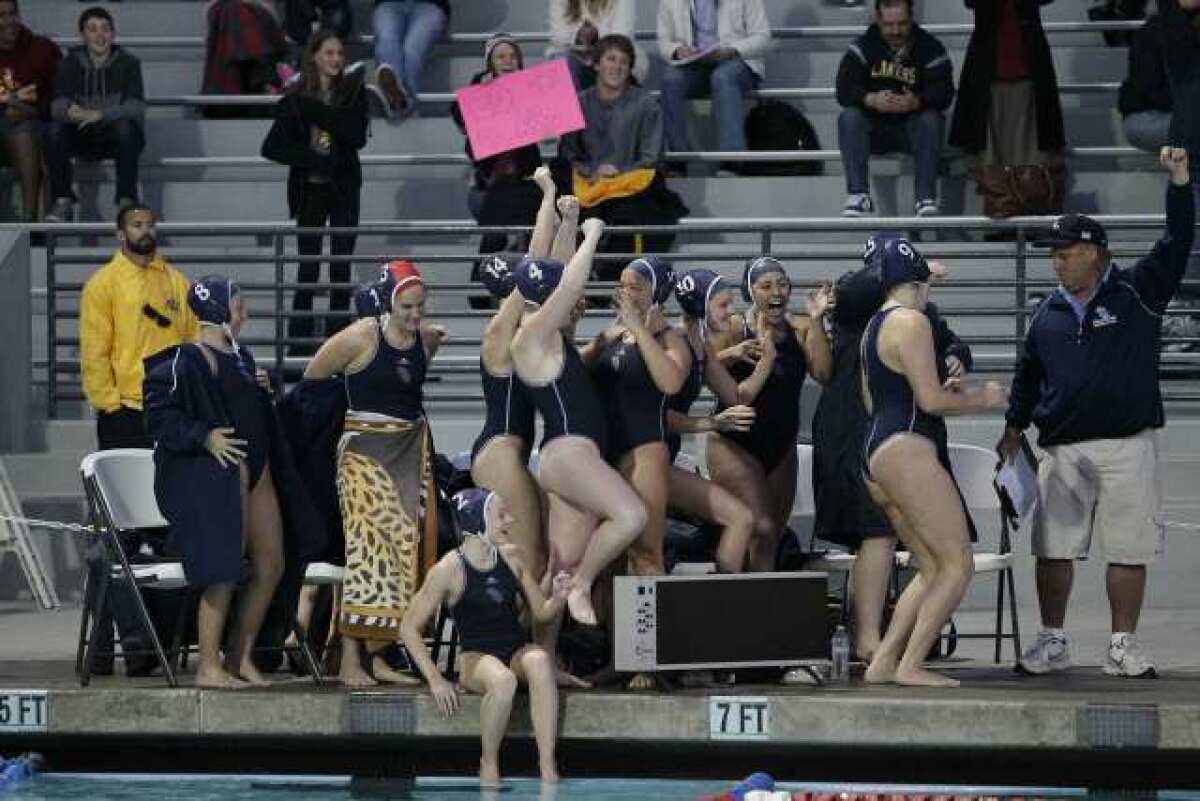 The Crescenta Valley High girls' water polo team celebrates a 10-5 victory over Riverside Poly in the CIF Southern Section Division V championship game at the William Woollett Aquatics Center. It's the Falcons' first-ever CIF title.