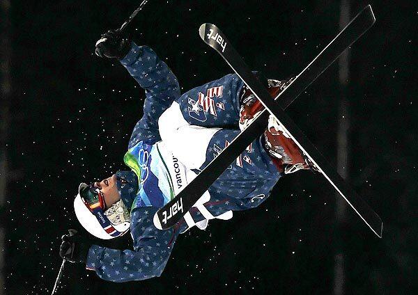 Bryon Wilson of the United States twists into his second maneuver on his way to a bronze medal in the men's moguls at Cypress Mountain outside Vancouver.