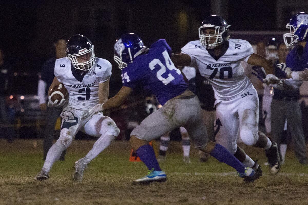 Newport Harbor's Justin McCoy maneuvers past St. Anthony's Sone Aupiu (24) for a first down in the first round of the CIF Southern Section Division 9 playoffs on Friday at Clark Field in Long Beach.