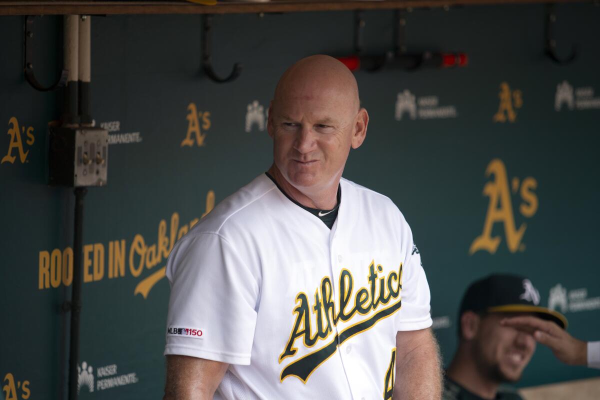 FILE - In this Sept. 22, 2019, file photo, Oakland Athletics third base coach Matt Williams is shown in the dugout before a baseball game against the Texas Rangers in Oakland, Calif. Back managing a team, just being able to talk with his players is a challenge for Matt Williams. About 10 miles from the spring training camps of the Boston Red Sox and Minnesota Twins, the 54-year-old is at spring training with South Korea's Kia Tigers. “You never know whether you’re going to get another chance to manager or not, so I look at it as a challenge or an opportunity,’’ he said, sitting in some small metal bleachers. “So far it’s been a lot of fun.” (AP Photo/D. Ross Cameron, File)