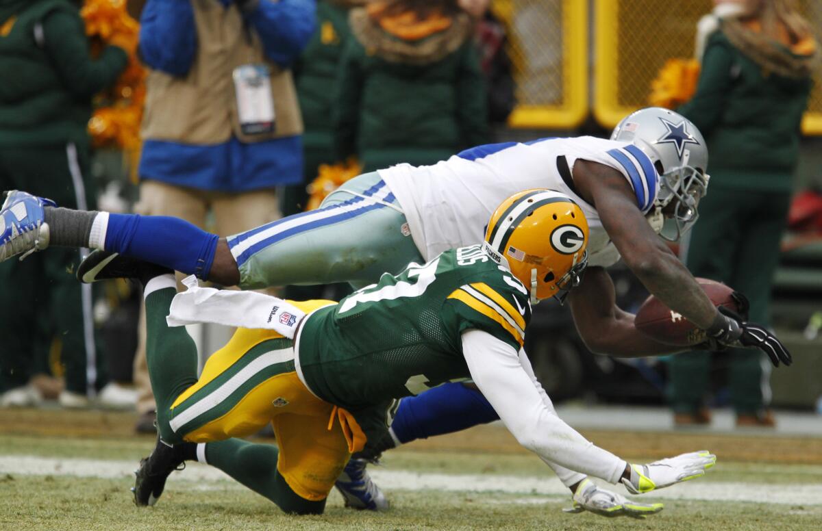 Cowboys wide receiver Dez Bryant catches a pass against Packers cornerback Sam Shields late in their 2014 playoff game. The call was reversed because Bryant was ruled to not have made a football move.