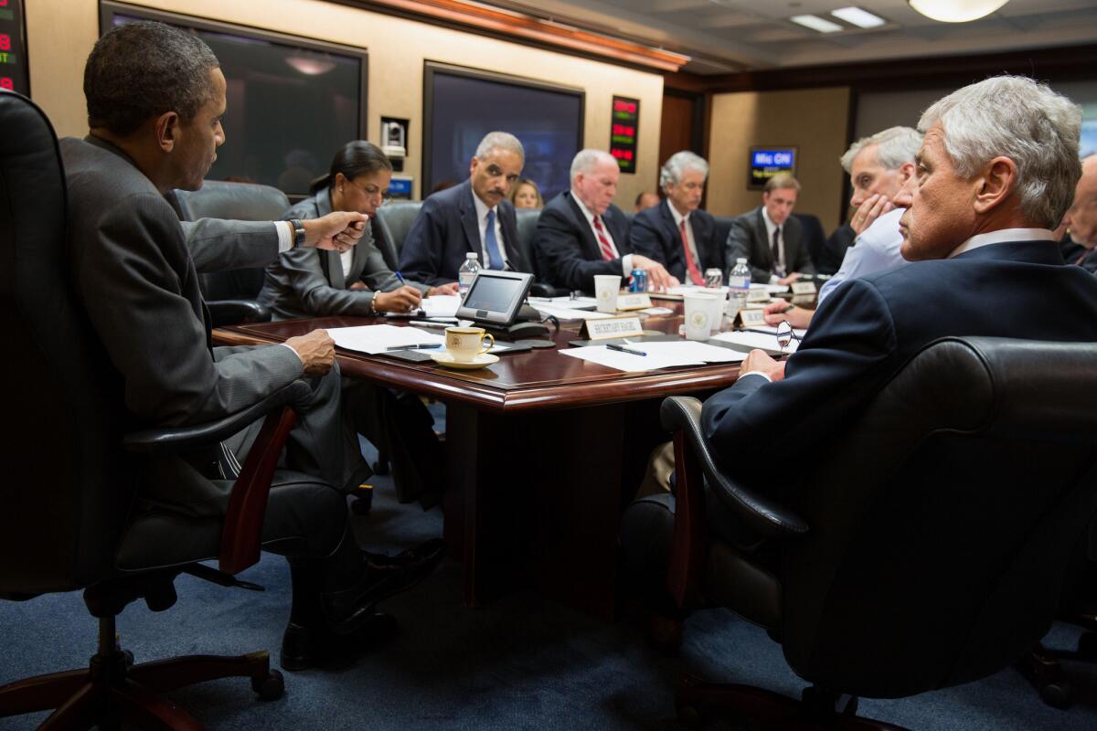 A photo provided by the White House shows President Obama meeting Wednesday in Washington with members of his national security team to discuss the situation in Egypt.