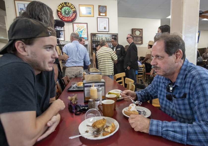 Two men eat lunch at Philippe the Original.