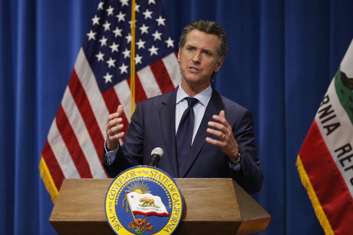 California Gov. Gavin Newsom speaking from behind a podium