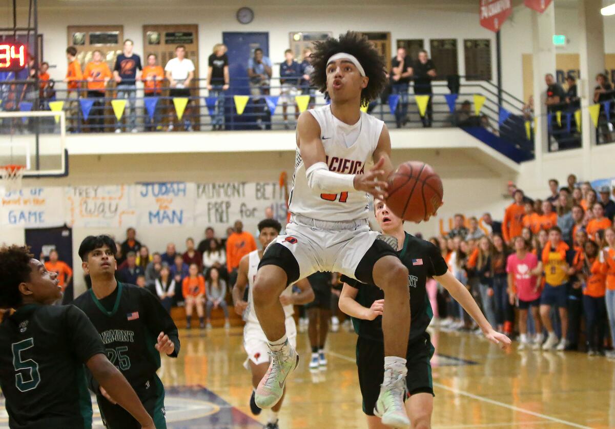 Pacifica Christian Orange County's Houston Mallette (31), shown on a fastbreak in a Jan. 31 game against Fairmont Prep, led the Tritons to an 81-74 win against Mira Costa on Friday in the second round of the CIF Southern Section Division 2A playoffs.