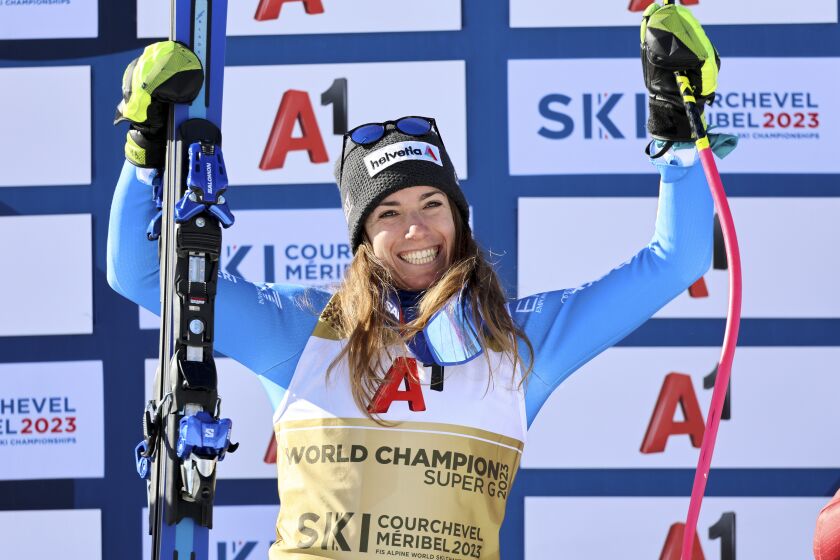 Italy's Marta Bassino celebrates winning an alpine ski, women's World Championships super G, in Meribel, France, Wednesday, Feb. 8, 2023. (AP Photo/Marco Trovati)