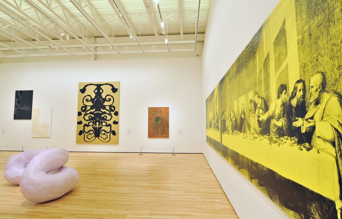 Andy Warhol's bright yellow "The Last Supper" hangs in a gallery with other works