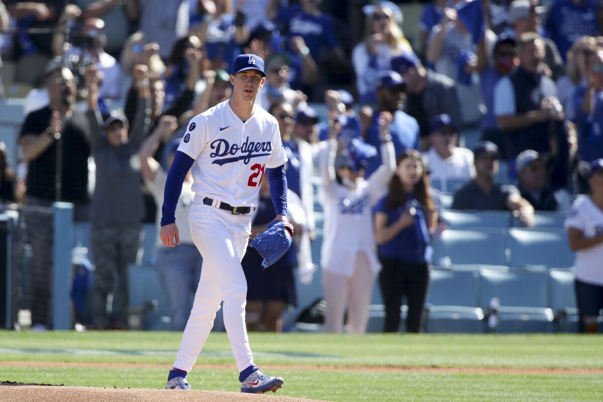Dodgers pitcher Walker Buehler walks off the mound after an out during the first inning against the Braves on Tuesday.