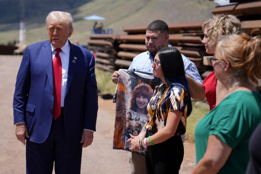 Republican presidential nominee former President Donald Trump speaks during a tour of the southern border with Mexico, Thursday, Aug. 22, 2024, in Sierra Vista, Ariz, as Alexis Nungaray, mother of Jocelyn, listens as Joamel Guevara holds a shirt with a photo of Jocelyn. (AP Photo/Evan Vucci)