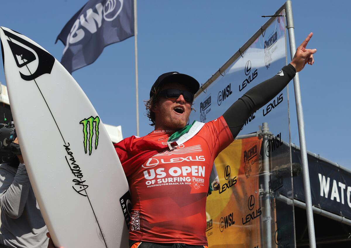 Alan Cleland of Mexico yells out "Viva Mexico" after winning the Men's final of the 2024 U.S. Open of Surfing competition. 