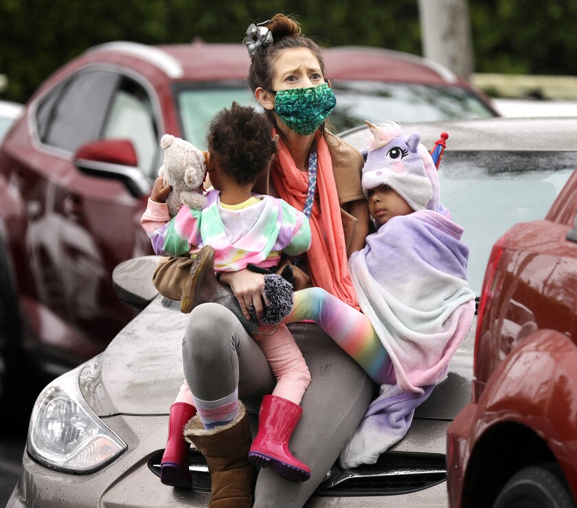 Ashley Amon, 33, and her daughters Alysha, 2, and Alexandria, 4, attend a drive-in Easter service in Santa Ana.