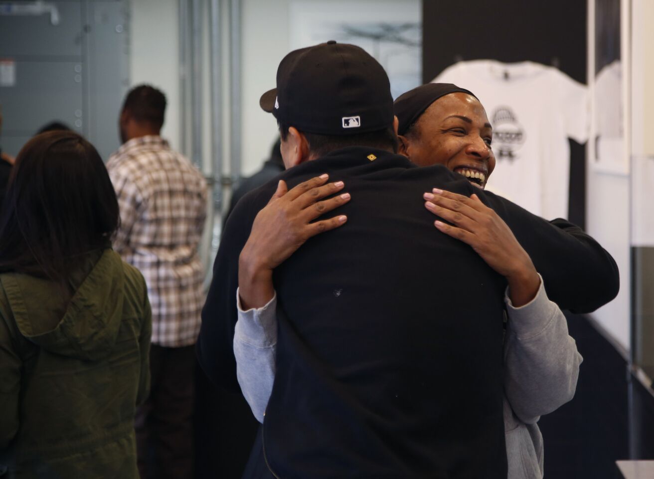 A woman, who didn't give her name, receives a hug from chef Roy Choi at LocoL.