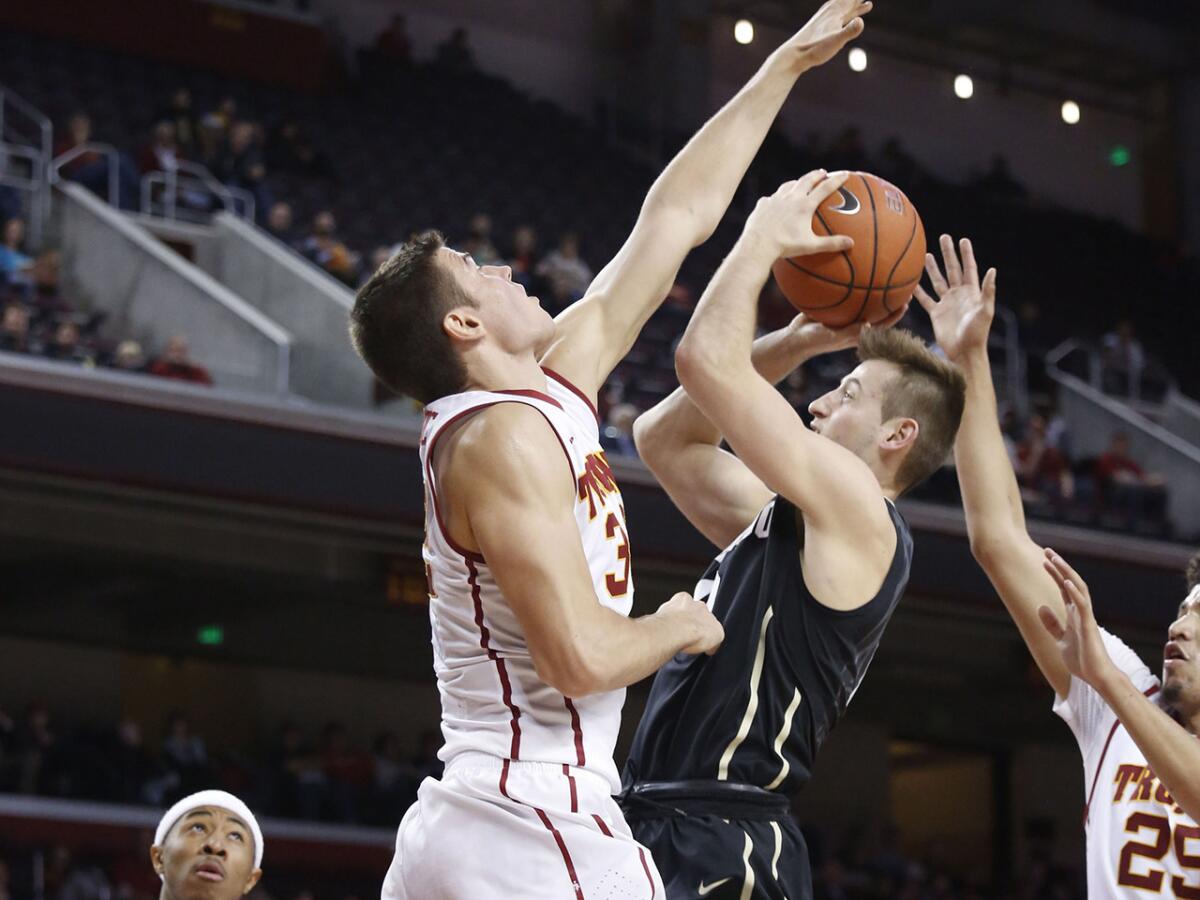 USC forward Nikola Jovanovic gets his hand in front of Colorado guard Eli Stalzer during a game Feb. 17 at the Galen Center.