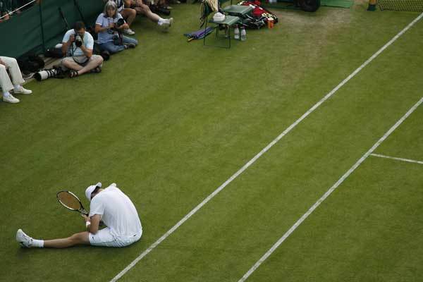 John Isner reacts to play against Nicolas Mahut during the Wimbledon Tennis Championships on June 23, 2010.