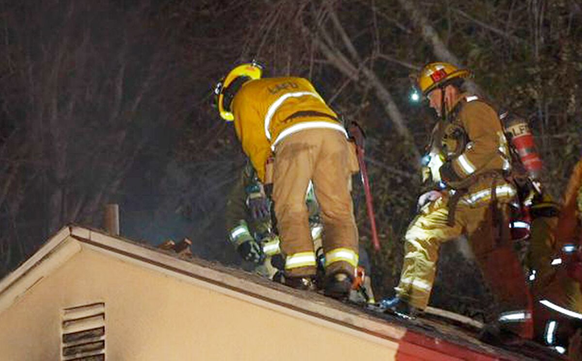 Firefighters on the roof of a house