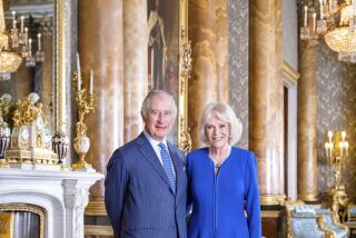 Britain's King Charles III and Camilla, Queen Consort pose  in the Blue Drawing Room at Buckingham Palace.
