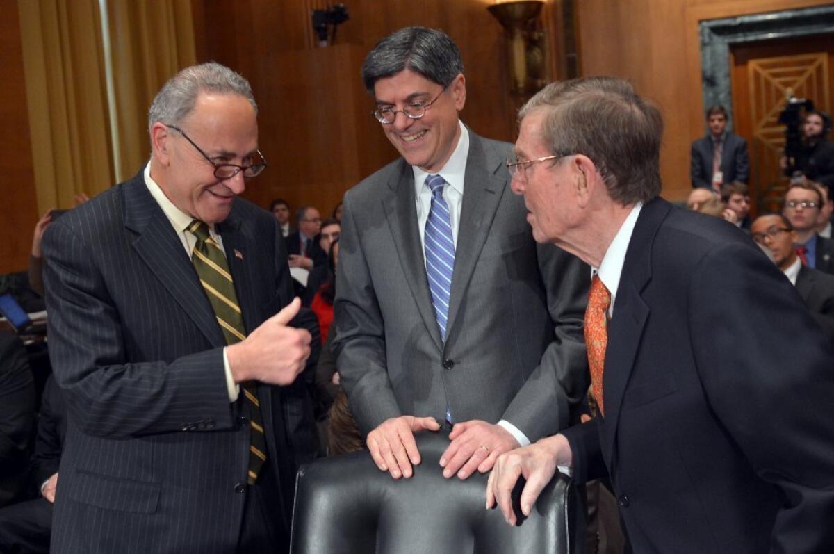 Jacob J. Lew, center, arrives to testify before the Senate Finance Committee on his nomination to be Treasury secretary, met by Sen. Charles E. Schumer (D-N.Y.), left, and former Sen. Pete Domenici (R-N.M.)., who introduced Lew to the panel.