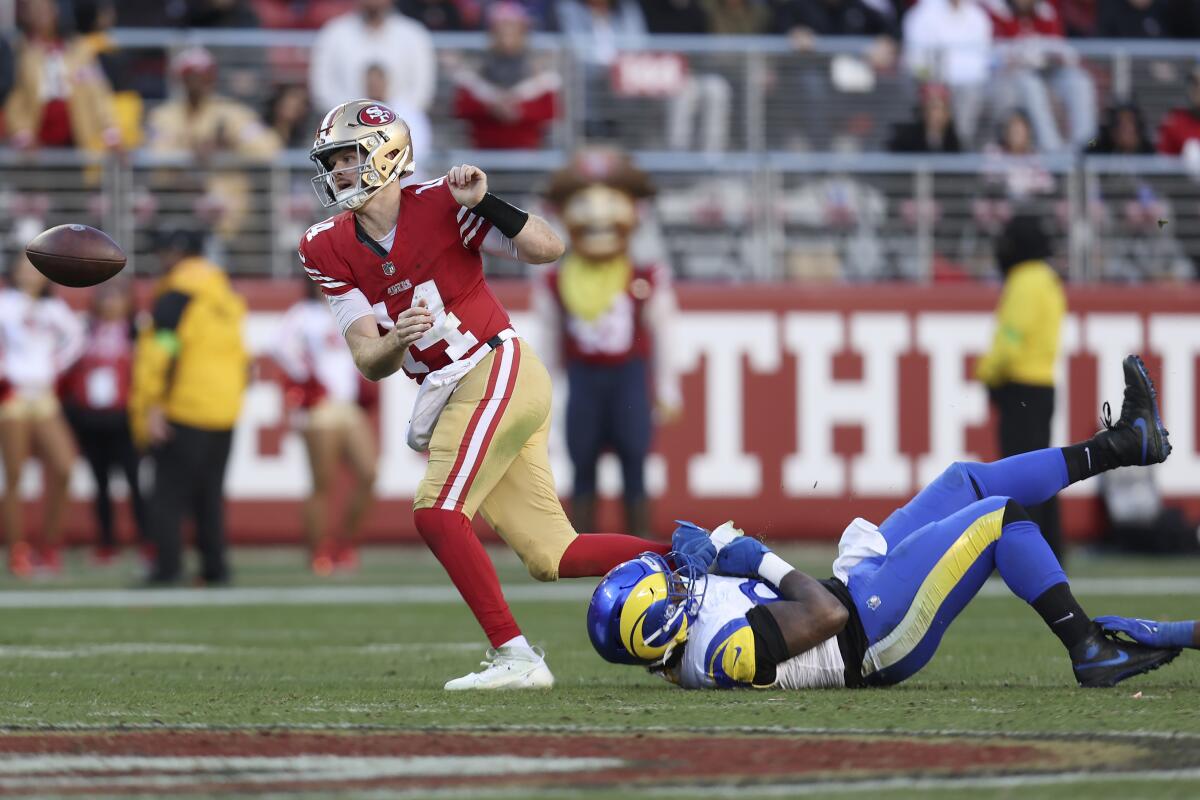 San Francisco 49ers quarterback Sam Darnold (14) fumbles in front of Desjuan Johnson. 