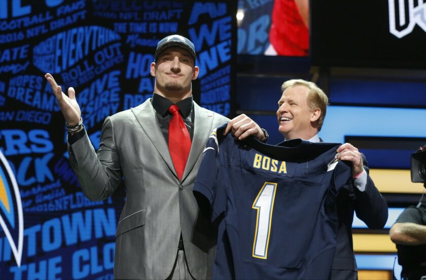 Ohio State’s Joey Bosa poses for photos with NFL commissioner Roger Goodell after being selected by the San Diego Chargers as the third pick in the first round of the 2016 NFL football draft, Thursday, April 28, 2016, in Chicago. (AP Photo/Charles Rex Arbogast)