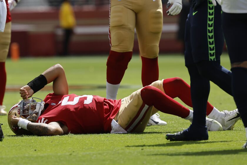 San Francisco 49ers quarterback Trey Lance (5) lies on the field after being tackled during the first half of an NFL football game against the Seattle Seahawks in Santa Clara, Calif., Sunday, Sept. 18, 2022. (AP Photo/Josie Lepe)
