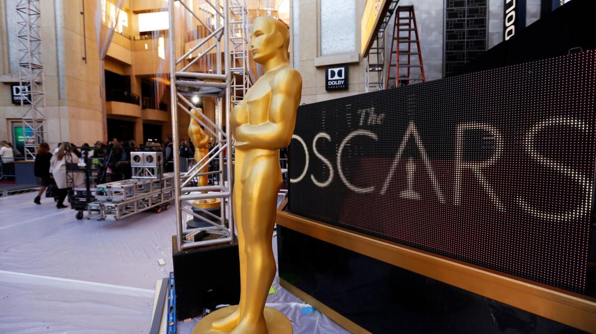 Workers make Oscar ceremony preparations in front of the Dolby Theatre in Hollywood on Thursday.