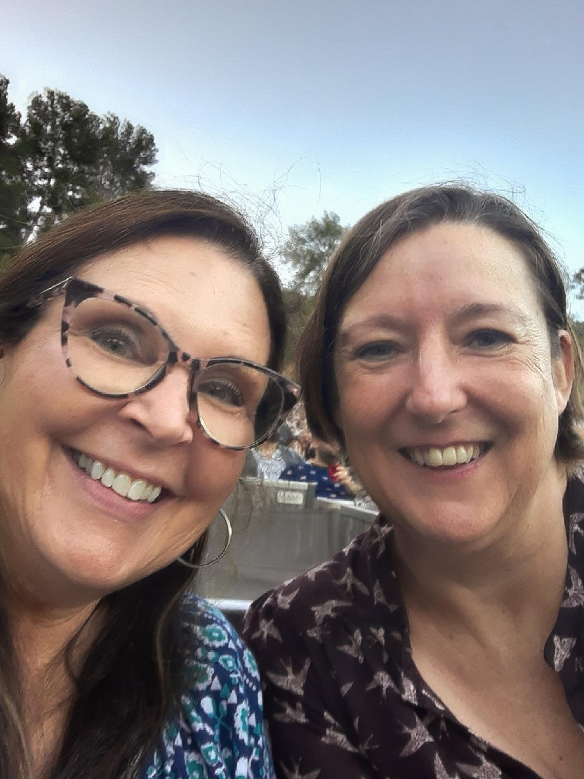 Two women smile and pose for a selfie.