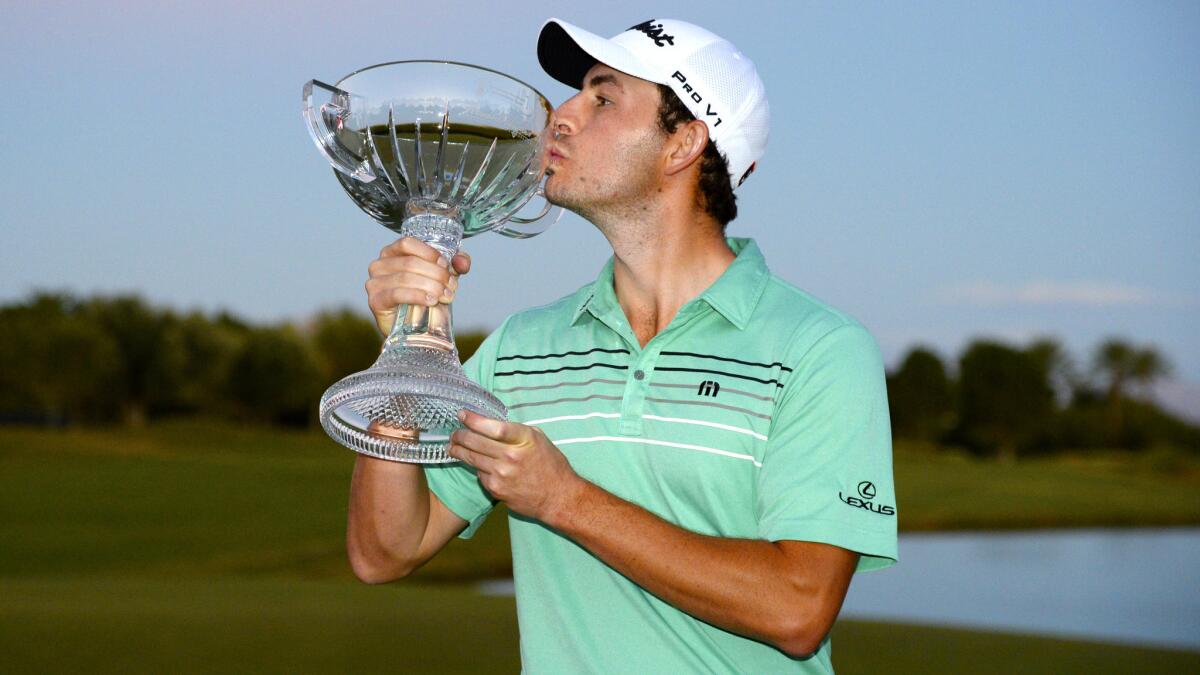 Patrick Cantlay celebrates with a kiss of the trophy after wining the Shriners Hospitals for Children Open on Sunday.