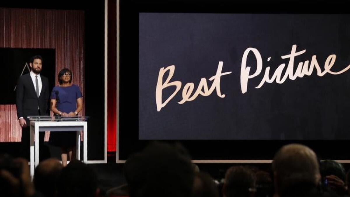 Academy president Cheryl Boone Isaacs, right, and actor John Krasinski announce the films nominated for best picture.
