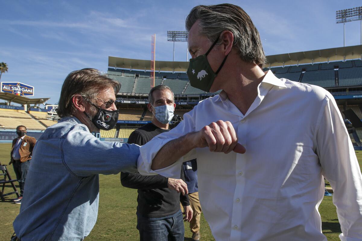 Actor Sean Penn with L.A. Mayor Eric Garcetti and Governor Gavin Newsom at the Dodger Stadium vaccination site.