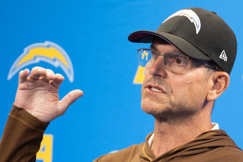 Chargers coach Jim Harbaugh speaks during a press conference.