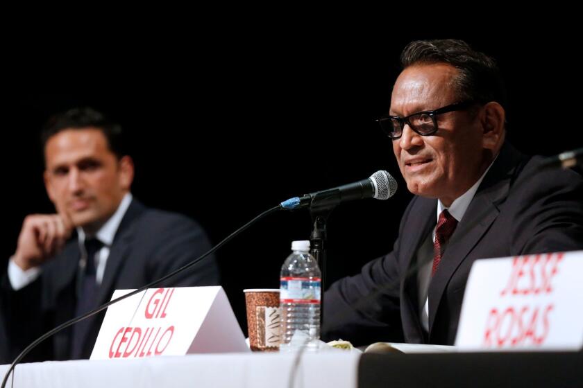 Challenger Joe Bray-Ali, left, and incumbent Gil Cedillo discuss issues earlier this month at a forum for City Council District 1 candidates.