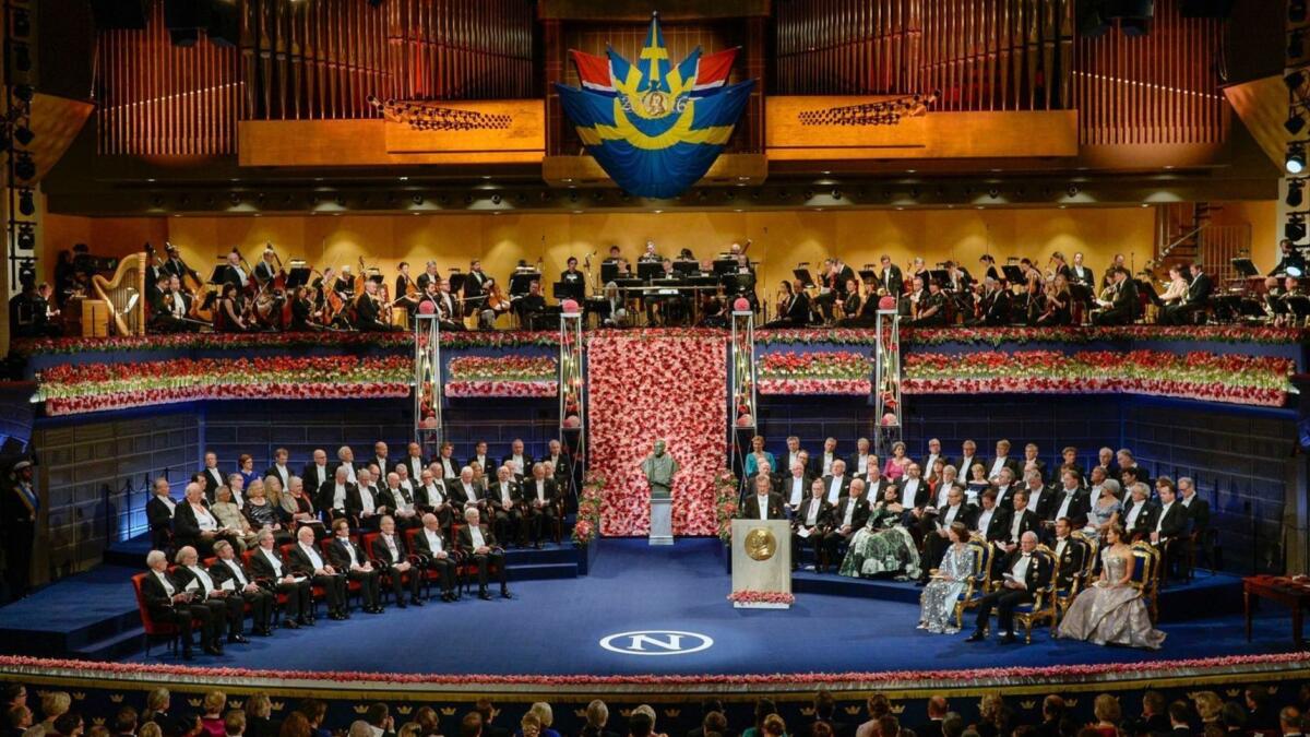 The 2016 Nobel laureates in literature, medicine, chemistry, physics and economics are seated, front row left across from King Carl XVI Gustaf of Sweden and the royal family.