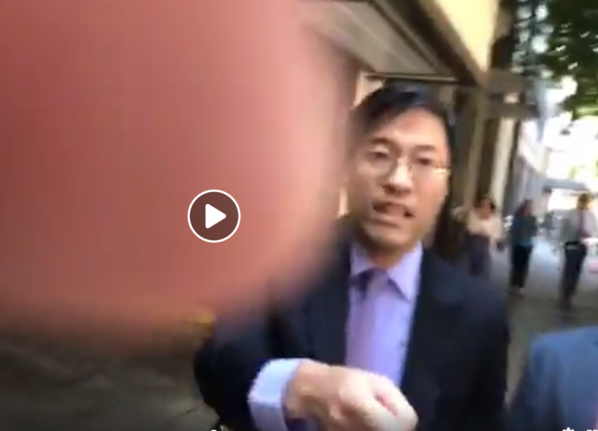 A still shot from a video of a man shoving state Sen. Richard Pan.