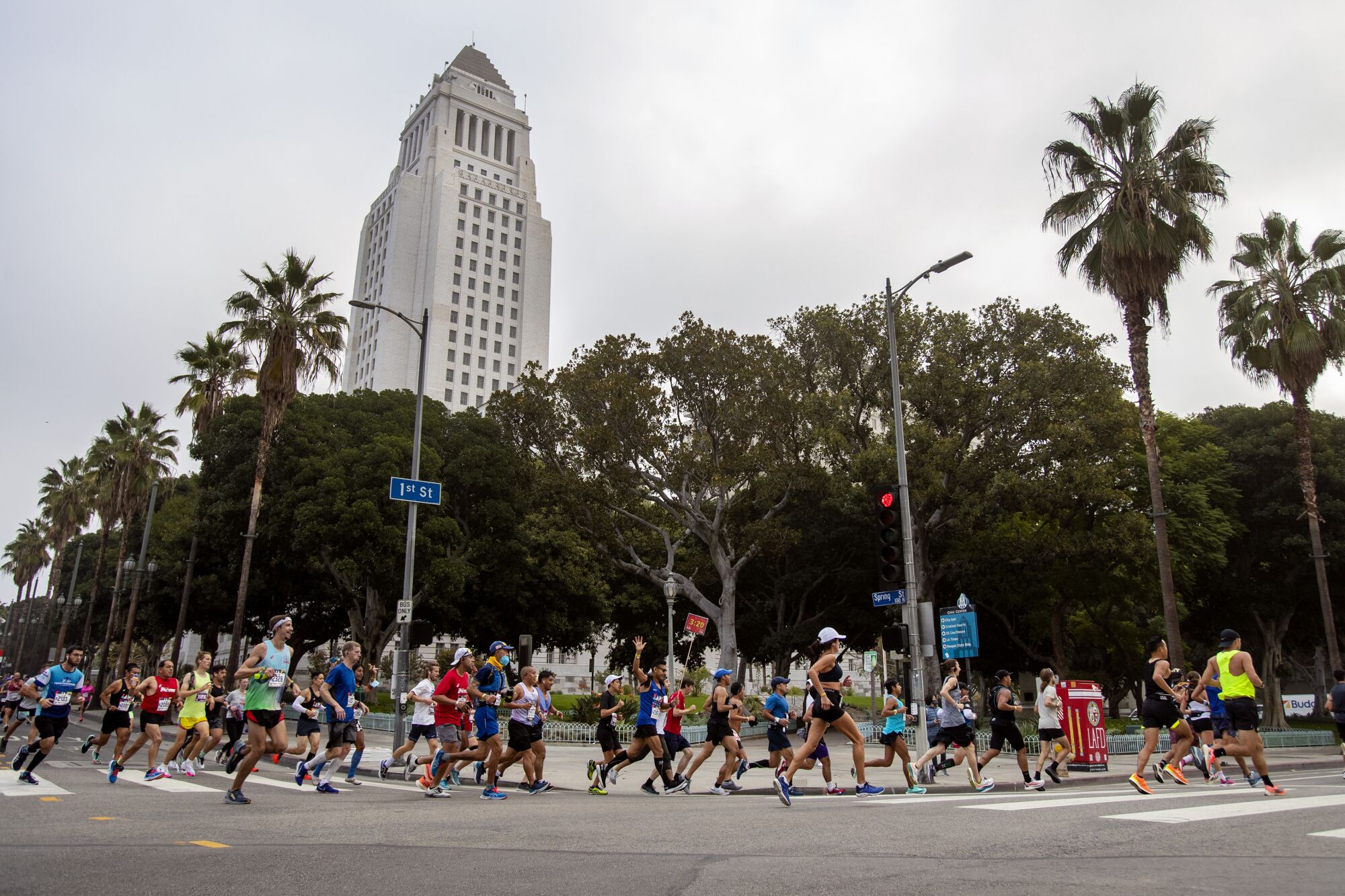 Runners make the turn onto 1st Street near City Hall at the three-mile mark during the L.A. Marathon.