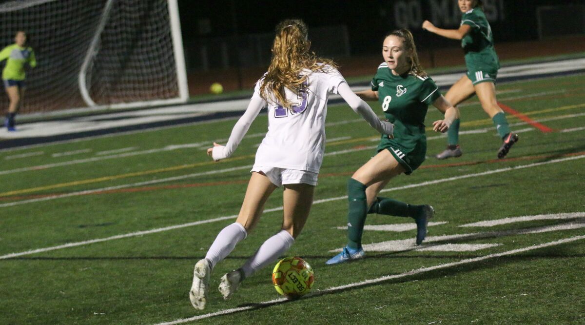 Junior Paige Hays (#8), marking Carlsbad's Lexi Wright, was part of a big LCC defensive effort.