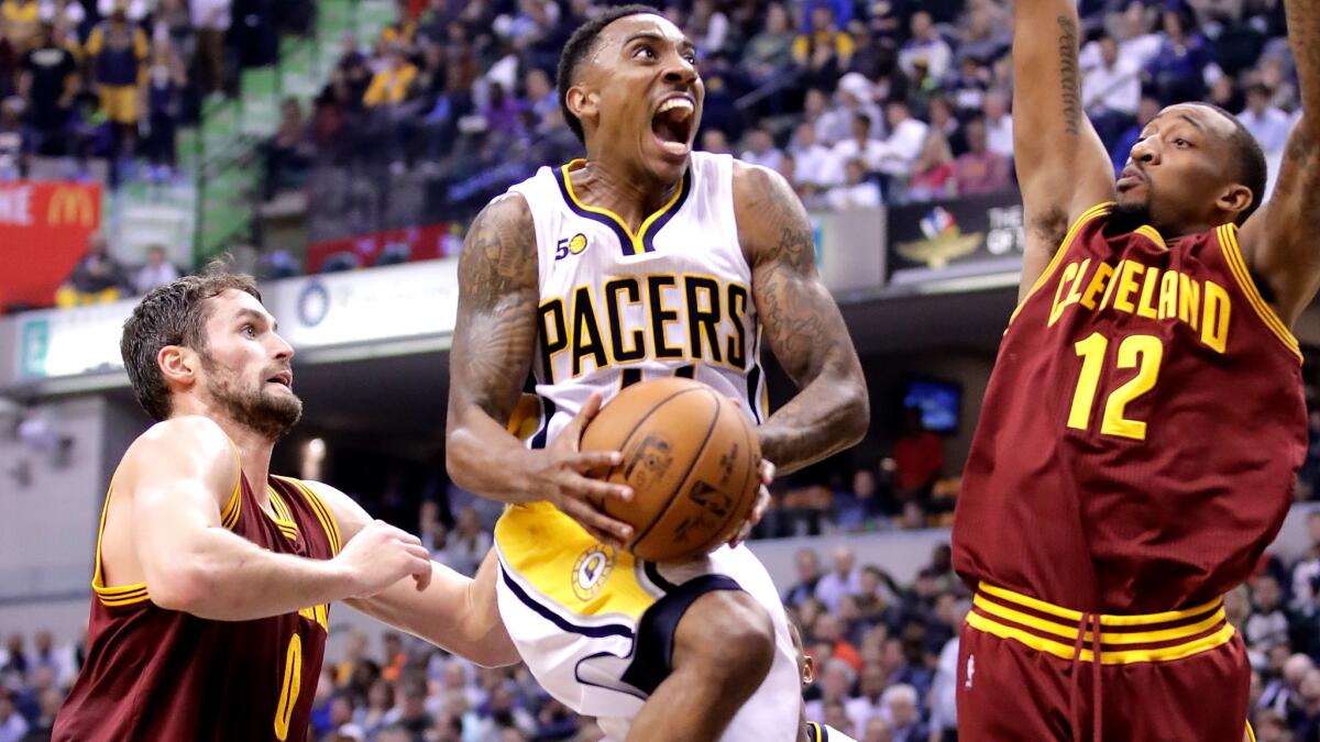 Pacers point guard Jeff Teague tries to split the defense of Cavaliers forward Kevin Love (0) and guard Jordan McRae (12) during their game Wednesday night.